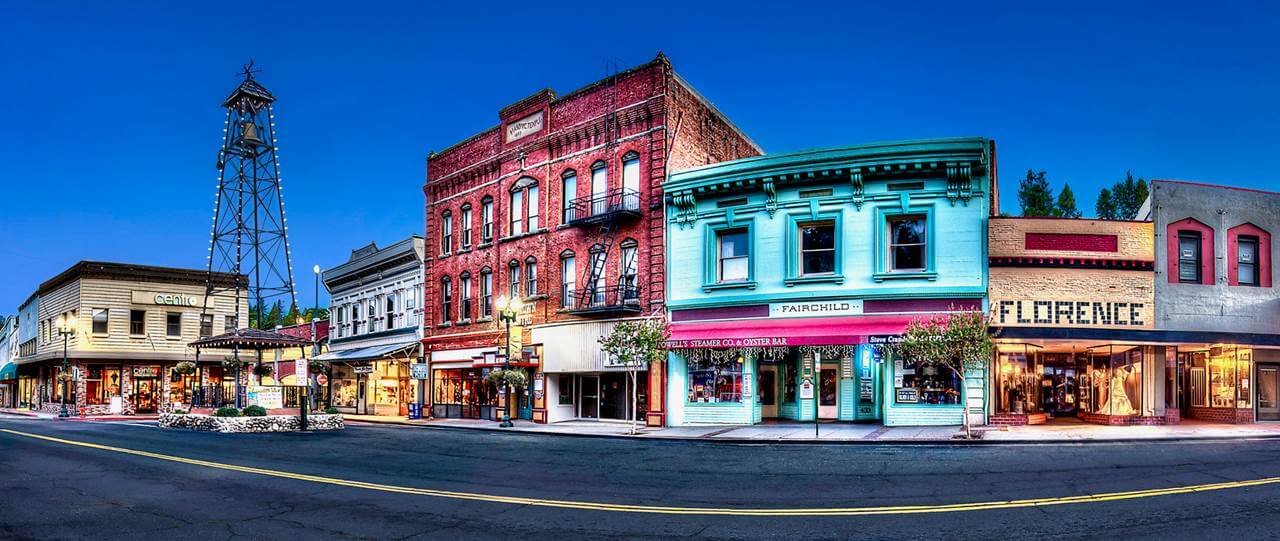 historic Main Street with the Bell Tower, brick storefronts, and flag-lined sidewalks